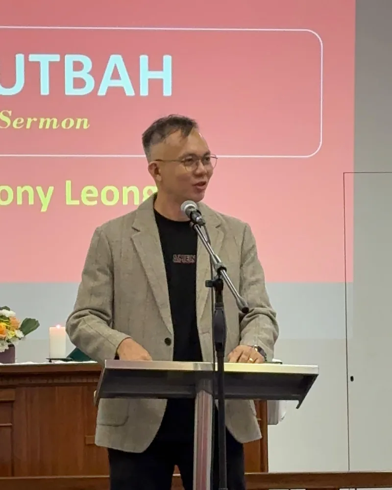 Pastor Jony preaching at a pulpit